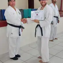 Sensei Nadia giving Sensei Nick his training attendance certificate 